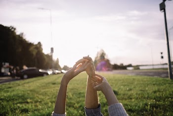 Three People Raising Their Hands