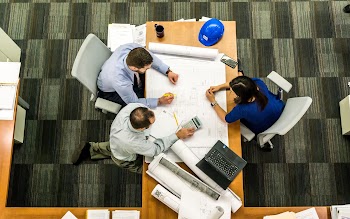 Three People Sitting Beside Table · Free Stock Photo