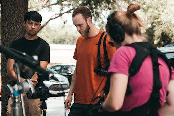 Three People Standing Near Bicycles