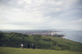 Three People Standing on Grassfield