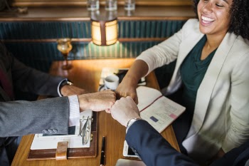 Three Person Fist Bump Inside Room