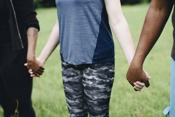 Three Person Hand and Hand to Each Other