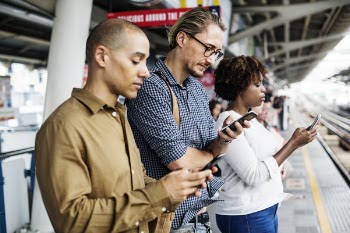 Three Person Holding Smartphones