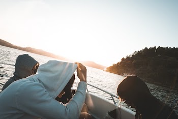 Three Person Wearing Hooded Jacket during Golden Hour