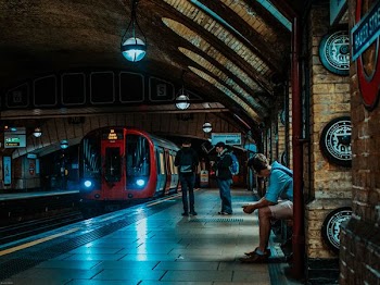 three persons waiting for train