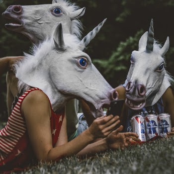 Three Persons Wearing Unicorn Costumes