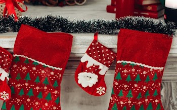 Three Red And Green Christmas Stocking Mounted On Wall