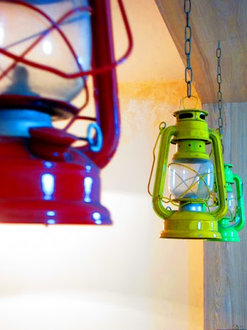 Three Red, Yellow, and Green Gas Lantern Hanging on Ceiling