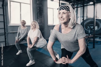 Three senior woman doing stretching together