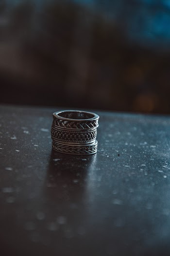Three Silver-colored Rings on Black Surface