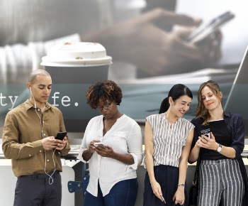 Three Women and One Man Looking on Smartphones