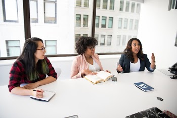 Three Women in Front of Desk