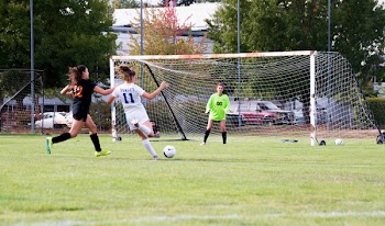 Three Women Playing Soccer Game