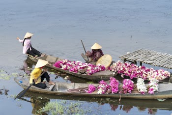 Three Women Sitting On Boats