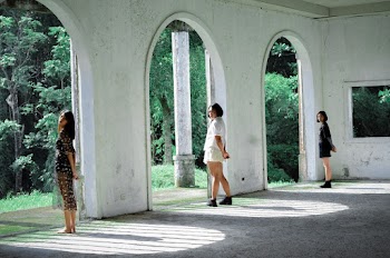 Three Women Standing Beside Concrete Wall