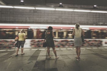 Three Women Standing in the Side of Running Train