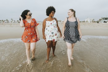 Three Women Walking at Shore
