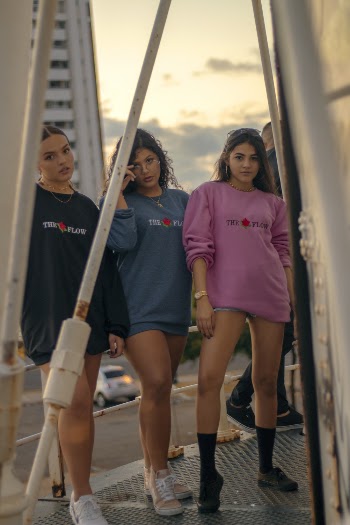 Three Women Wearing Different Colors Of Sweaters