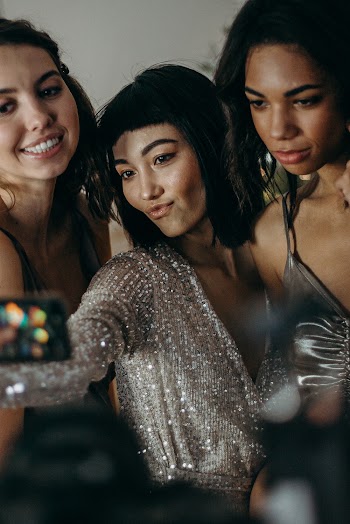 Three Women Wearing Grey and Black Tops