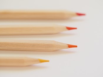 Tilt Shift Lens Photography of Orange Coloring Tool