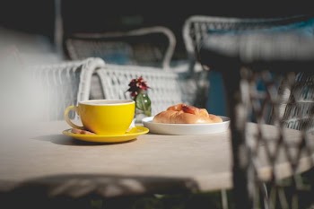tilt-shift photography of yellow mug on table