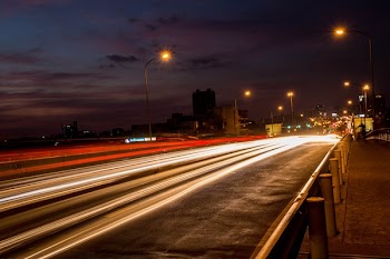 Time Lapse Photo of Bridge and Highrise Buildings