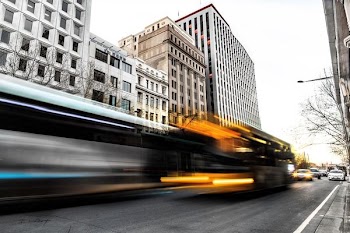 time lapse photo of buses and cars on road at daytime