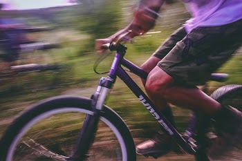 Time Lapse Photo Of Man Riding On Bicycle