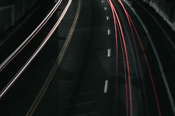 time lapse photo of vehicle passing through road