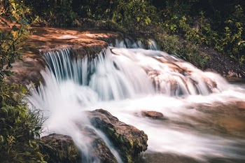 Time lapse Photo of Waterfall Surrounded by Grass