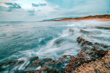 Time Lapse Photography of Body of Water on Cliff