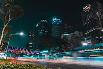 Time Lapse Photography Of Cars Passing On The Road Near Buildings