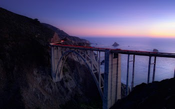 Time Lapse Photography of Cars Running on Bridge Near Ocean