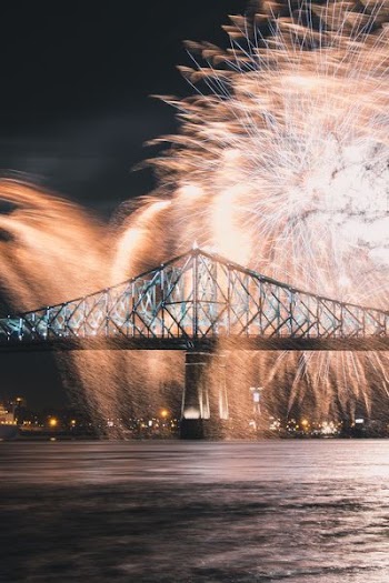 time lapse photography of fireworks over bridge