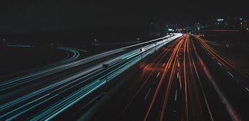 time lapse photography of lighted road at night