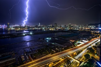 Time-Lapse Photography of Lightning Above Lighted Buildings During Night