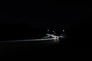 time-lapse photography of moving vehicles on road
