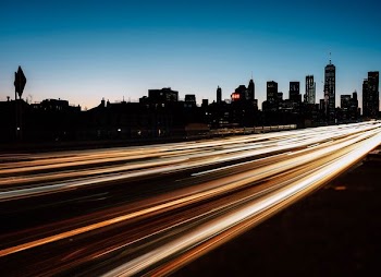 time lapse photography of passing vehicles on road