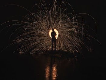 time lapse photography of person standing in front of lights