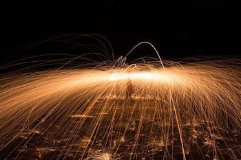 time-lapse photography of person using lit steel wool