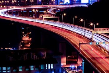 time lapse photography of road with cars near building at night