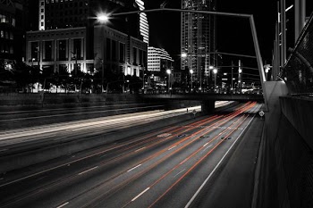 time lapse photography of vehicle on bridge during nighttime