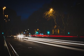 time lapse photography of vehicle passing on road at night
