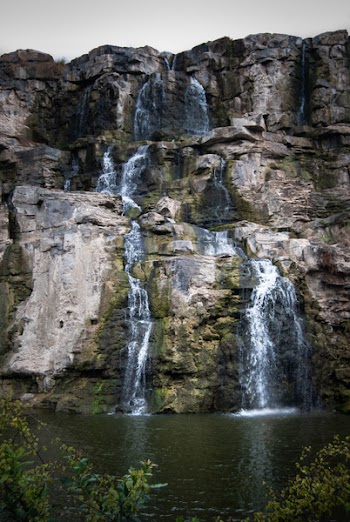 Timelaps Photo of White Green and Black Rock Falls during Daytime