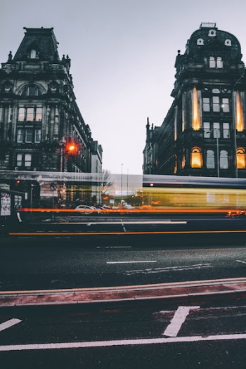 Timelapse Photography of Vehicle Near High-rise Building