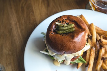 Tiny pickles on top of burger 
