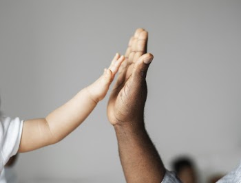 Toddler and Adult Doing Hand Gestures