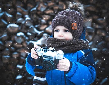 toddler holding camera