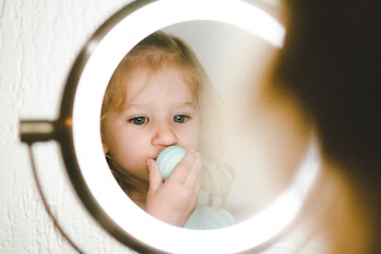 Toddler in Front of Round Stainless Steel Led Vanity Mirror