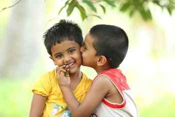 Toddler Kissing Smiling Girl